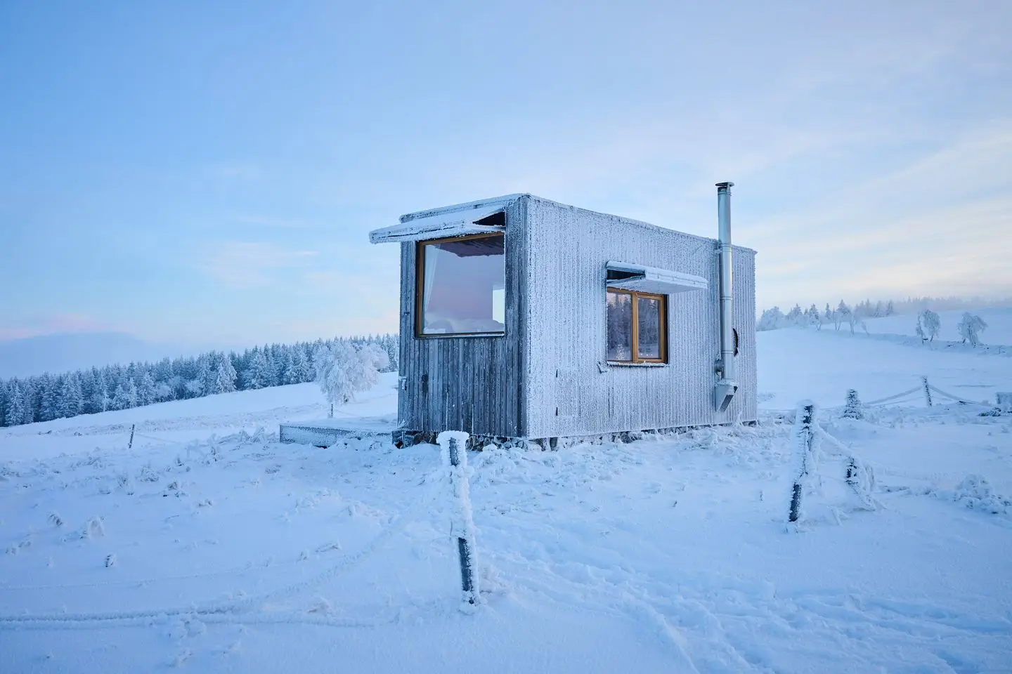 Snow-covered meadow around the glamping retreat Na Malém Háji