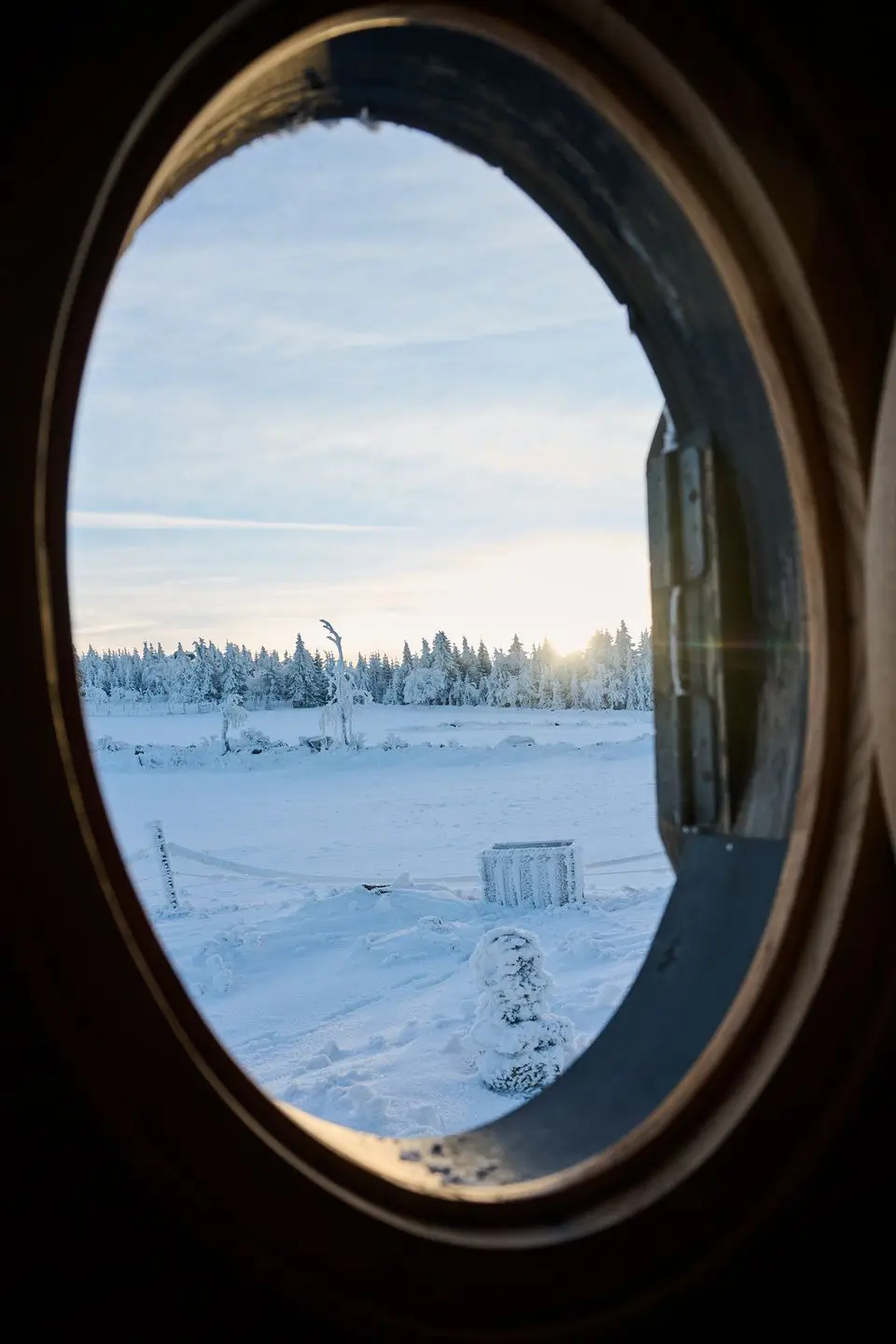 Detail of the snow-covered facade of the glamping tiny house Na Malém Háji